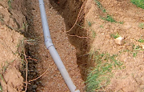Underground sewer line repair in an open trench